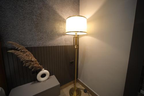 a lamp in a bathroom with a roll of toilet paper at The Cozy Chaos in Agra