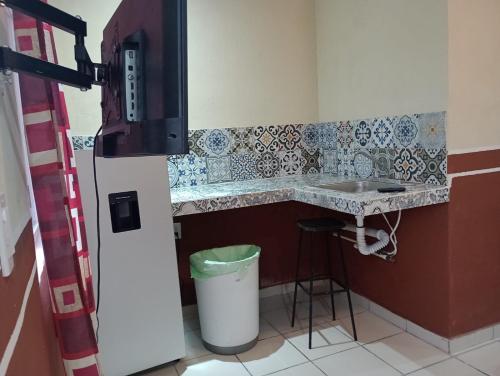 a kitchen with a counter and a sink and a trash can at LOSSANTOS in Matamoros