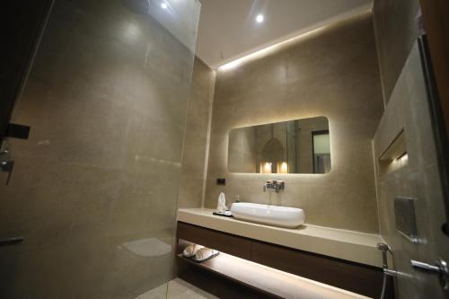 a bathroom with a sink and a mirror at The Cozy Chaos in Agra