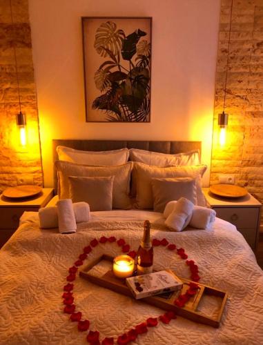 a bedroom with a bed with a tray with a bottle of champagne at Pensiunea PORTAS RESORT in Slănic