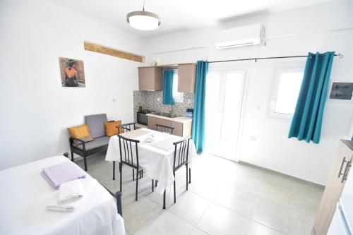 a kitchen and dining room with a table and chairs at House with view sound of waves in Paránimfoi