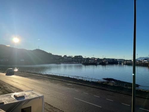 a view of a body of water with the sun setting at An Bothan in Mallaig