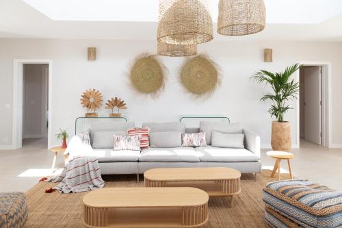 a living room with a couch and two tables at Ereza White Homes in Caleta De Fuste