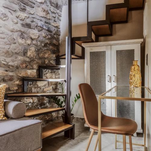 a living room with a glass table and a chair at Pyrgi Cretan Living & Spa in Pírgos