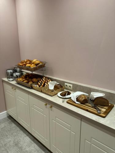 a buffet with bread and pastries on a counter at Privat-Hotel Villa Aurora in Bad Neuenahr-Ahrweiler