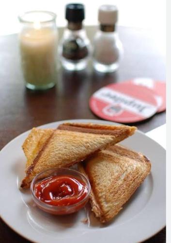 a plate of toast with ketchup on a table at HOTEL A.K.INTERNATIONAL INN in Ullāl
