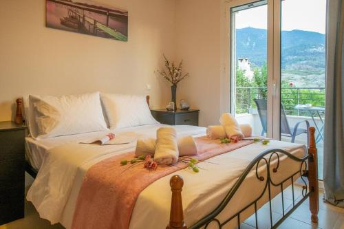 a bedroom with a large bed with flowers on it at Chillax House Near The Sea by Athenian Keys in Káto Alepokhórion