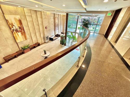 a lobby with a staircase in a building at NATURE Hotel By K D H in Da Nang