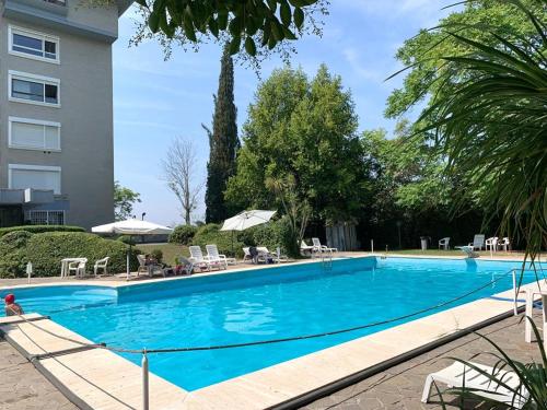 a large blue swimming pool next to a building at Aurelia Garden in Rome