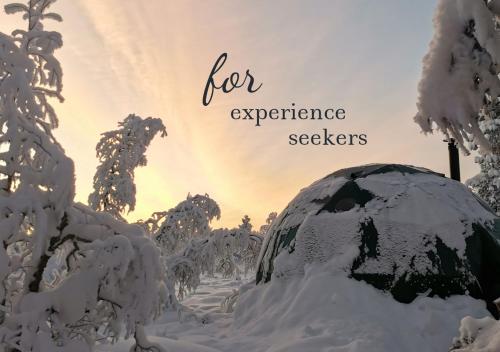 a snow covered garden with the words for experience seekers at Arctic Nature Experience Glamping in Vuontisjärvi