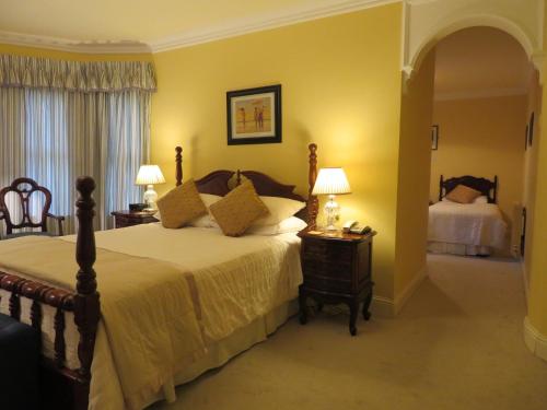 a bedroom with a bed and two lamps on tables at Brook Manor Lodge in Tralee