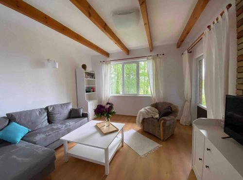 a living room with a couch and a table at Dom nad brzegiem Jeziora in Augustów