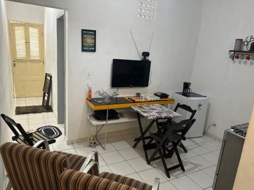 a living room with a table and a television at Betesda 2197F in São Luís