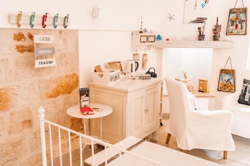 a kitchen with a table and chairs in a room at Karen House B&B in Polignano a Mare