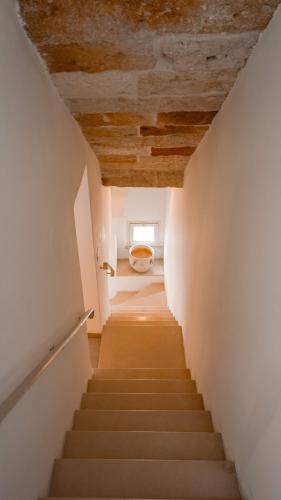 a staircase leading up to a bathroom with a toilet at Karen House B&B in Polignano a Mare