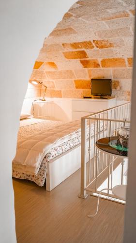 a bed in a room with a brick wall at Karen House B&B in Polignano a Mare