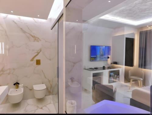 bagno bianco con servizi igienici e lavandino di Suite Èlite Rooms a Peschici