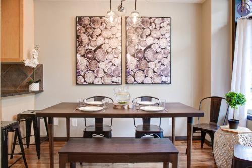 a dining room with a table and a painting on the wall at Grotto Canyon Chalet in Canmore