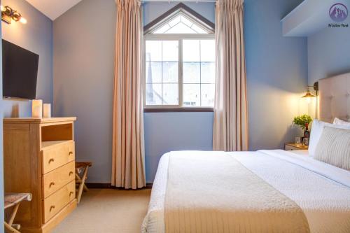 a bedroom with a bed and a window at Grotto Canyon Chalet in Canmore