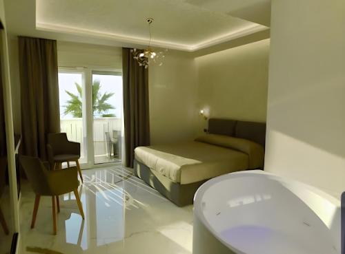 a bedroom with a bed and a table and a chair at Suite Èlite Rooms in Peschici