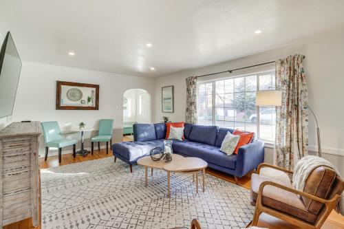 a living room with a blue couch and a table at Less Than 1 Mi to Midtown Pet-Friendly Home in Reno! in Reno