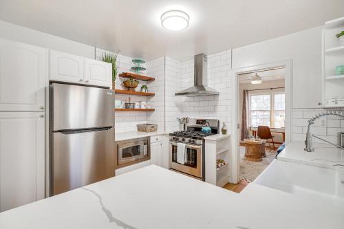 a kitchen with a stainless steel refrigerator and a sink at Less Than 1 Mi to Midtown Pet-Friendly Home in Reno! in Reno