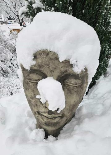 a statue of a head covered in snow at Ferienwohnung Karin in Bludenz