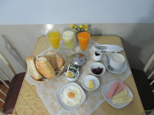 a table with breakfast foods and drinks on it at Hotel Panamericano in Lima