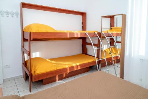 Habitación con 2 literas y sábanas amarillas. en SE038 - Senigallia, nuovo bilocale accessoriato a due passi dal mare, en Senigallia