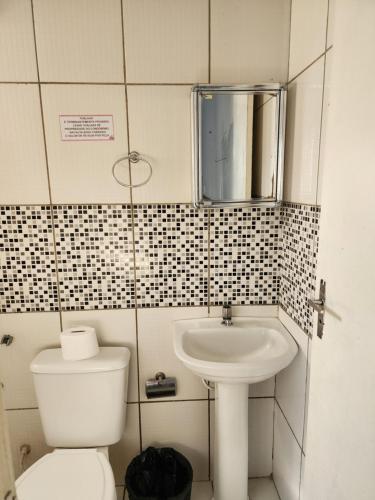 Baño pequeño con aseo y lavamanos en Condomínio Center luz, en Teresina