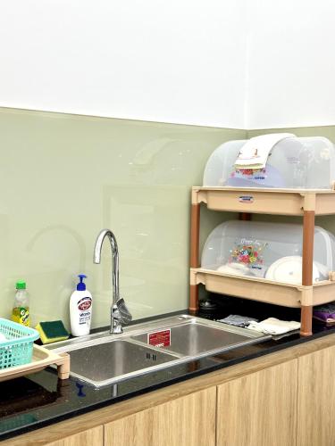 a kitchen counter with a sink and a sink at Aboli Homestay in Phan Thiet