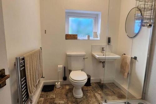 a bathroom with a toilet and a sink at Spacious Guest Flat near Roundhay Park in Roundhay