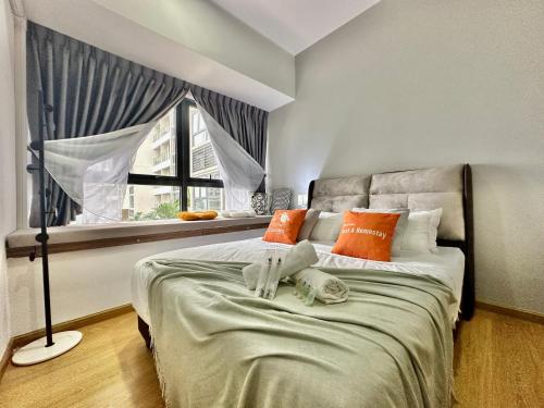 a bedroom with a bed with orange pillows and a window at DangaBay in CountryGarden - Fantastic2 #Cowidea in Johor Bahru