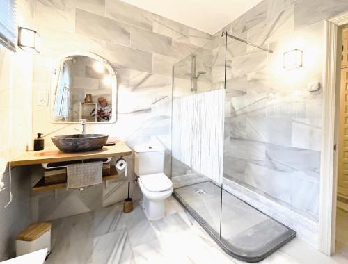 a bathroom with a shower and a toilet and a sink at Villa Aurelia Sea views Heatable Pool - Billiard Ping-pong Fooball table - Beach & All at 500 m in La Cala de Mijas
