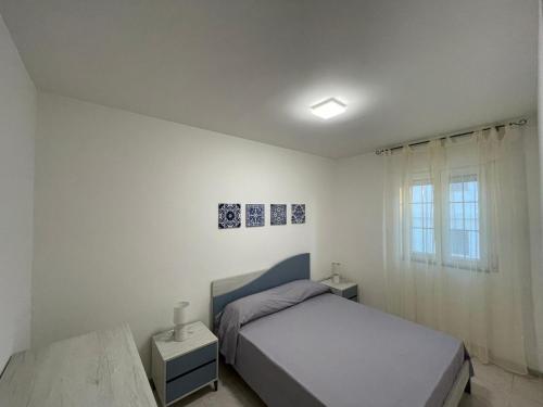 Ένα ή περισσότερα κρεβάτια σε δωμάτιο στο Residenza La Ginestra Posto Vecchio