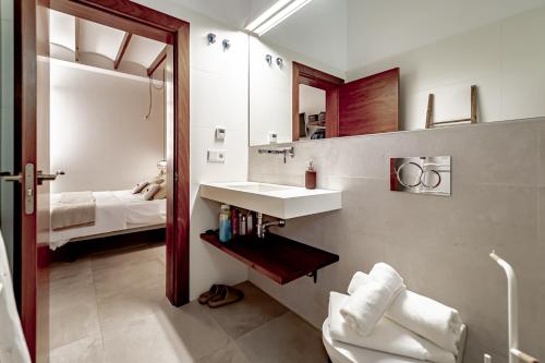 a bathroom with a sink and a mirror and a bed at Villa JAP in Benidorm