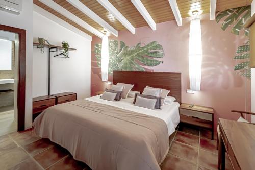 a bedroom with a large bed with white sheets and pillows at Villa JAP in Benidorm