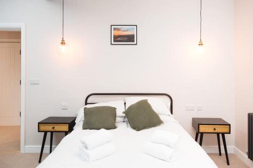 ein Schlafzimmer mit einem Bett mit zwei Nachttischen in der Unterkunft The Bankers Quarters - Apt 2 in Chapel en le Frith
