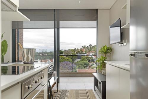 a kitchen with a large window with a view at 601 at 2SIX2 Florida Road by HostAgents in Durban