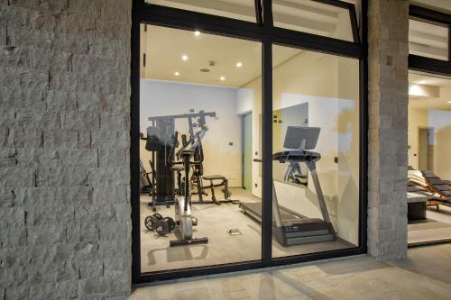 a room with a gym with a mirror at Villa Rita Pool & Spa in Mascalucia