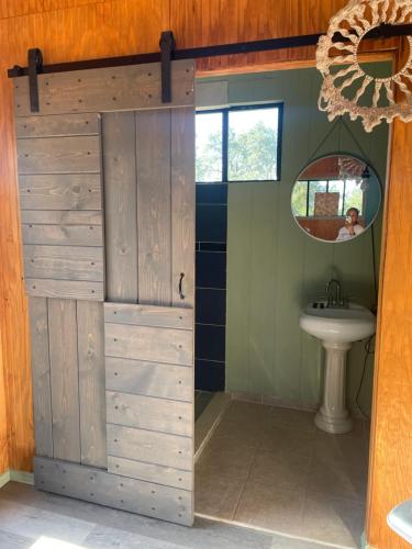 a sliding door in a bathroom with a sink at En Suite Flora in Dripping Springs