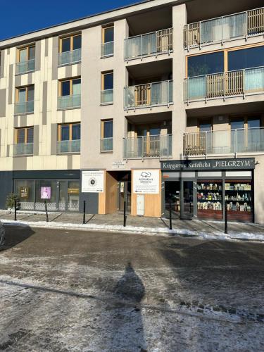 a shadow of a person standing in front of a building at ALEKSANDRA1 - SILENT in Kielce