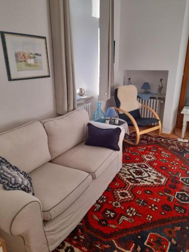 a living room with a couch and a chair at Kurpension Parkfrieden in Bad Pyrmont