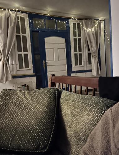 a bedroom with a blue door and a bench and a mirror at Das Haus am Meer in Safaga 