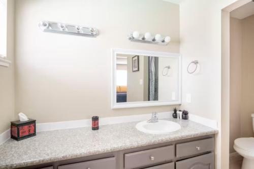 a bathroom with a sink and a mirror at Pool 4 bedroom 2 bath close to Strip in Las Vegas
