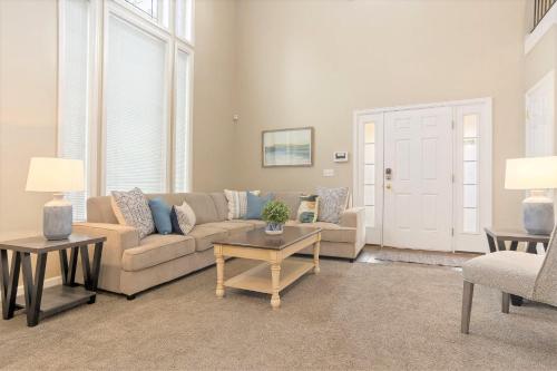 a living room with a couch and a table at Union Duplex in Salt Lake with Hot Tub and Park in Midvale
