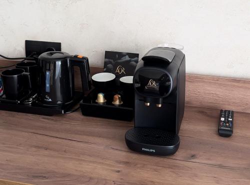 a coffee maker sitting on top of a wooden table at GirskiDelux in Bukovel