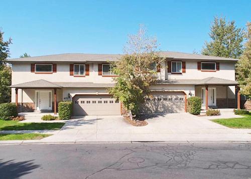 a large house with a garage and a driveway at Union Cove 3-Plex in Salt Lake with Hot Tub in Midvale