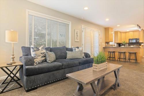 a living room with a couch and a table at Union Cove 3-Plex in Salt Lake with Hot Tub in Midvale