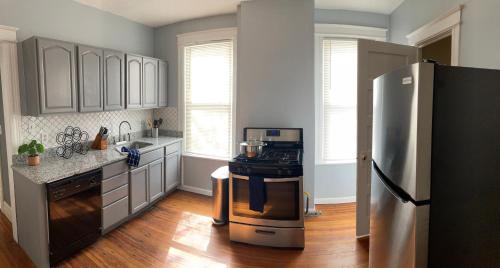 a kitchen with a stove and a refrigerator at Perfect for Families and Traveling Professionals in Albany